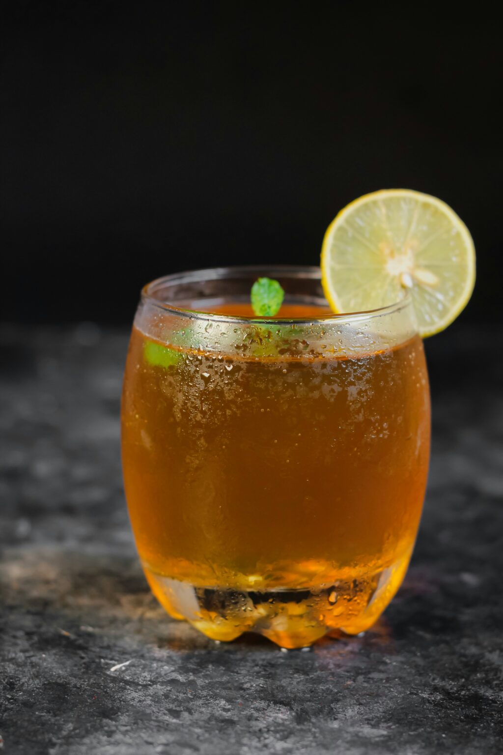 hot cinnamon whiskey and ginger beer cocktail in glass with slice of lime